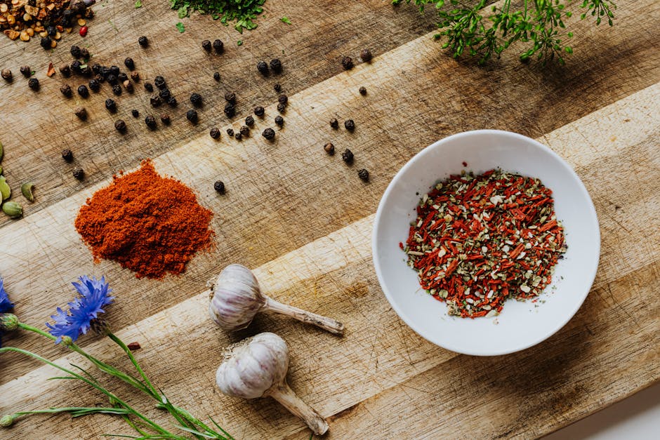 A Clove a Day Keeps the Pills Away: How Not To Die Series - Post # 2 A rustic flat lay of various spices and herbs on a wooden surface.