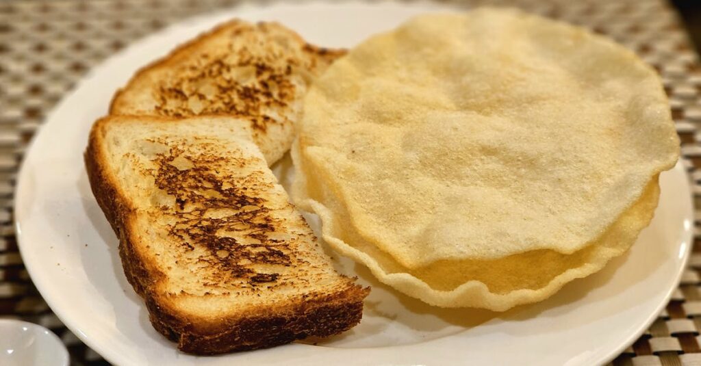A plate featuring crispy toasted bread and papadum, ready to eat.
