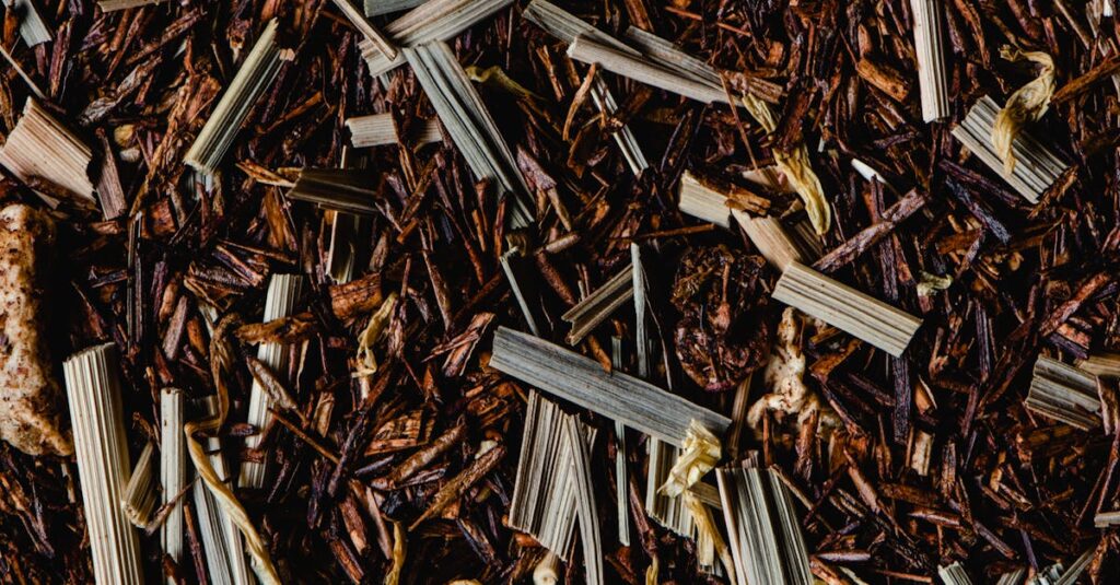 Close-up of dried rooibos and lemongrass blend highlighting texture and color.