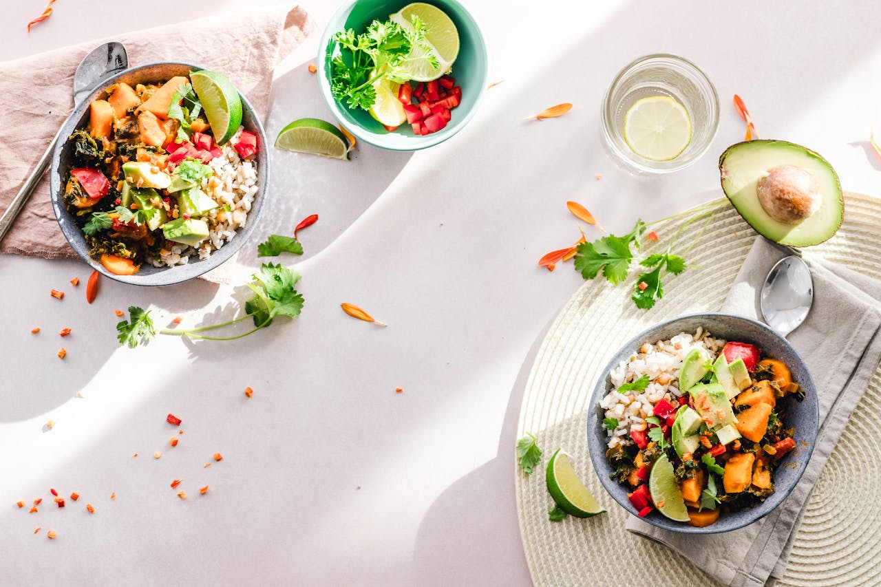 Home Top-down view of vibrant vegan bowls filled with fresh vegetables, perfect for a healthy meal.