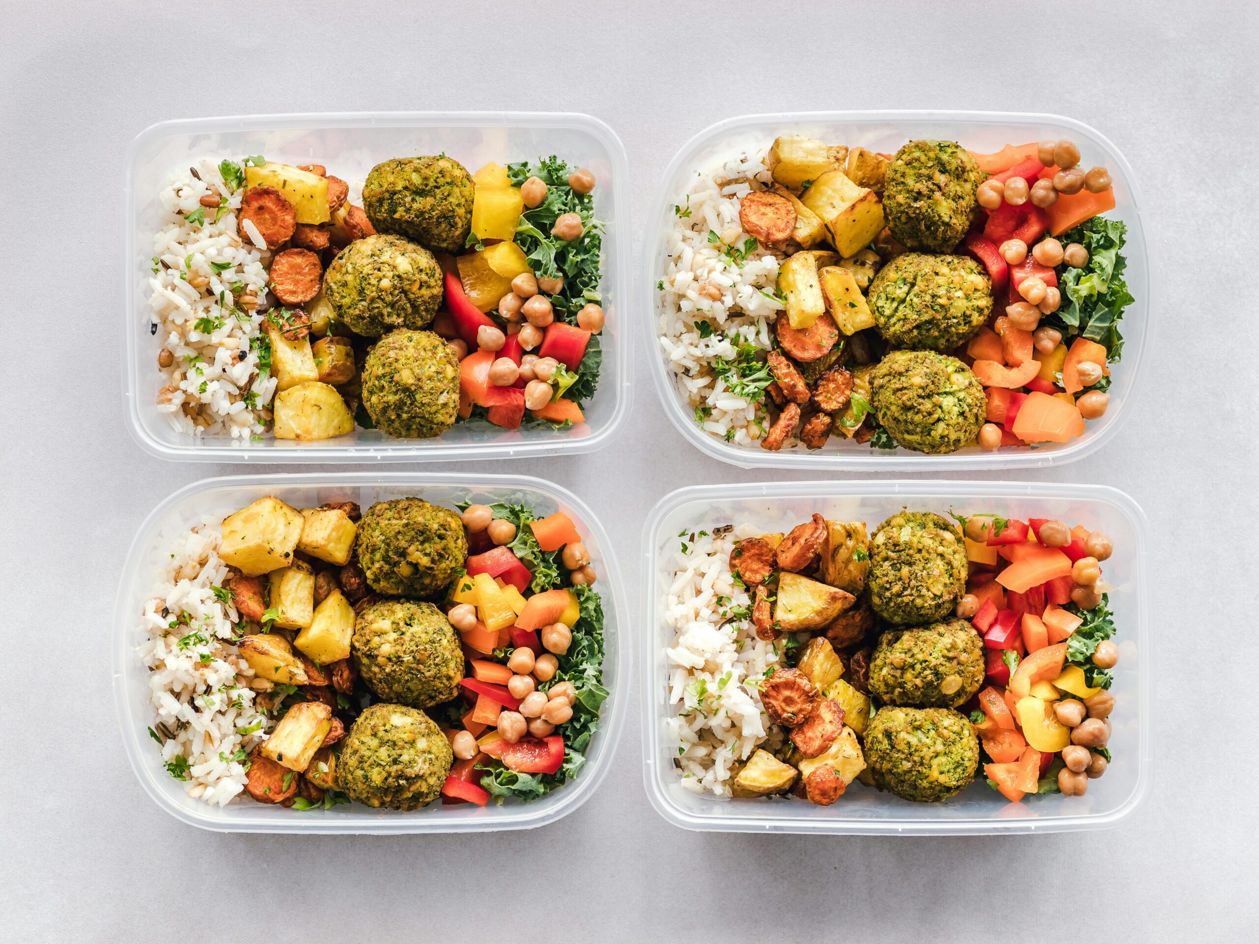 Eat Food That Looks Like a Crayon Box: The Simple Secret to Living Longer π Colorful meal prep containers with falafel, chickpeas, rice, and vegetables for a healthy lifestyle.